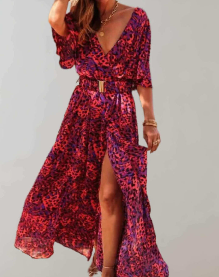Detailed view of a vibrant floral print on a loose fit women's midi dress with an elegant side slit.