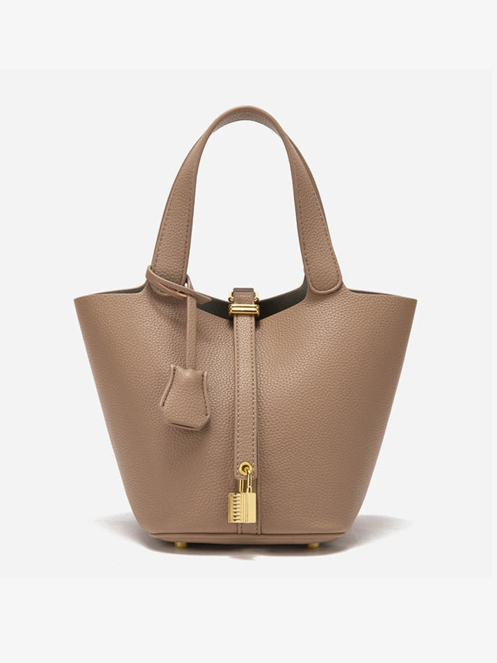 Modern women's leather crossbody bucket bag. Sophisticated accessory for on-the-go fashion.