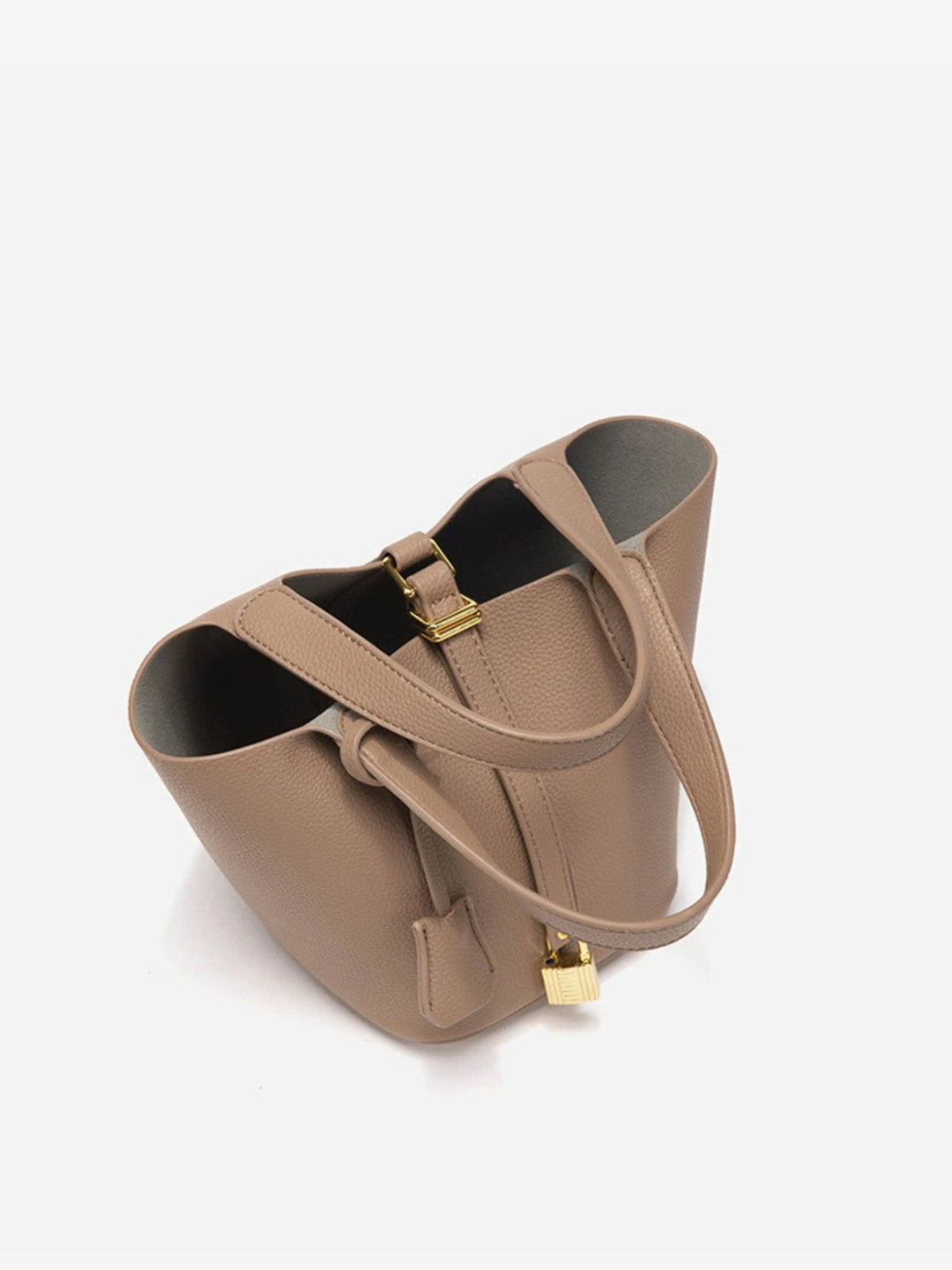 Close-up of the rich, supple leather texture of the women's modern bucket bag, a luxe accessory.