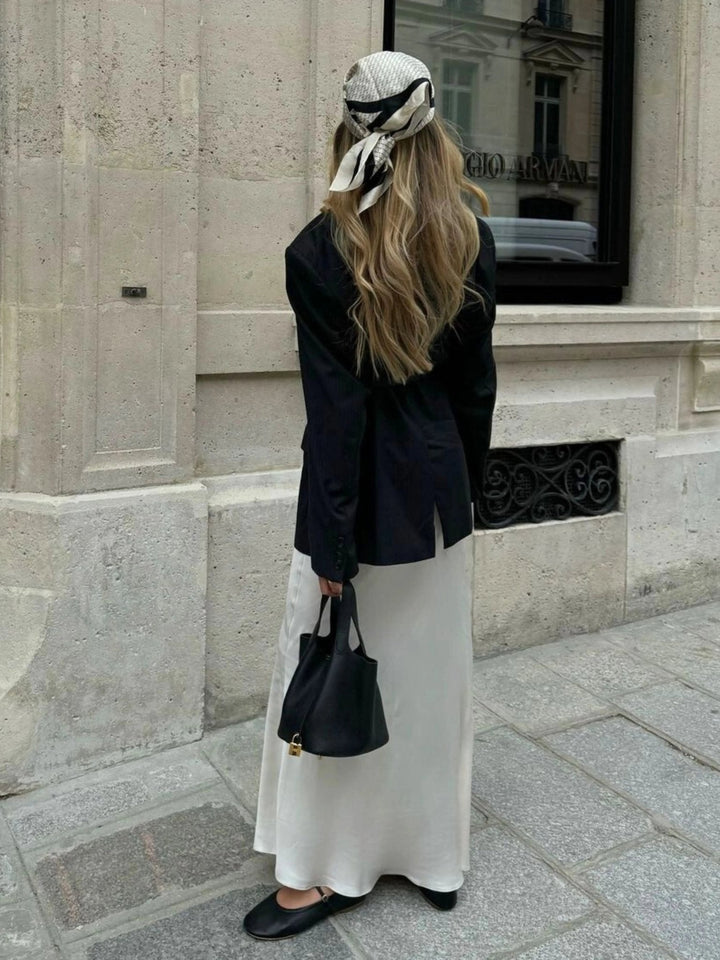Women's modern leather bucket bag complementing a chic casual outfit for everyday sophistication.
