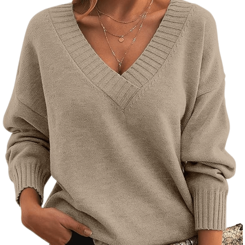 Woman in a soft V-neck cashmere sweater, showcasing elegant premium knitwear detail.