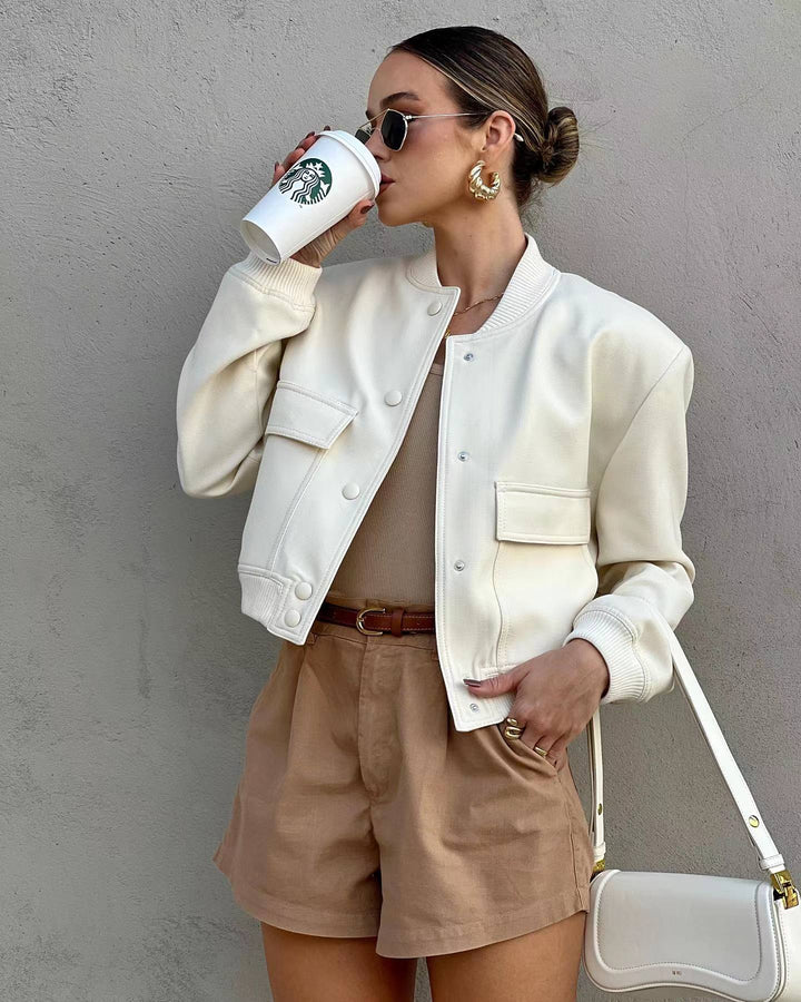 Woman wearing a trendy cropped bomber jacket, perfect for casual streetwear and fall outfits.