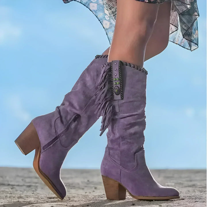 Stylish women's mid-calf western boots featuring playful fringe and a comfortable block heel.