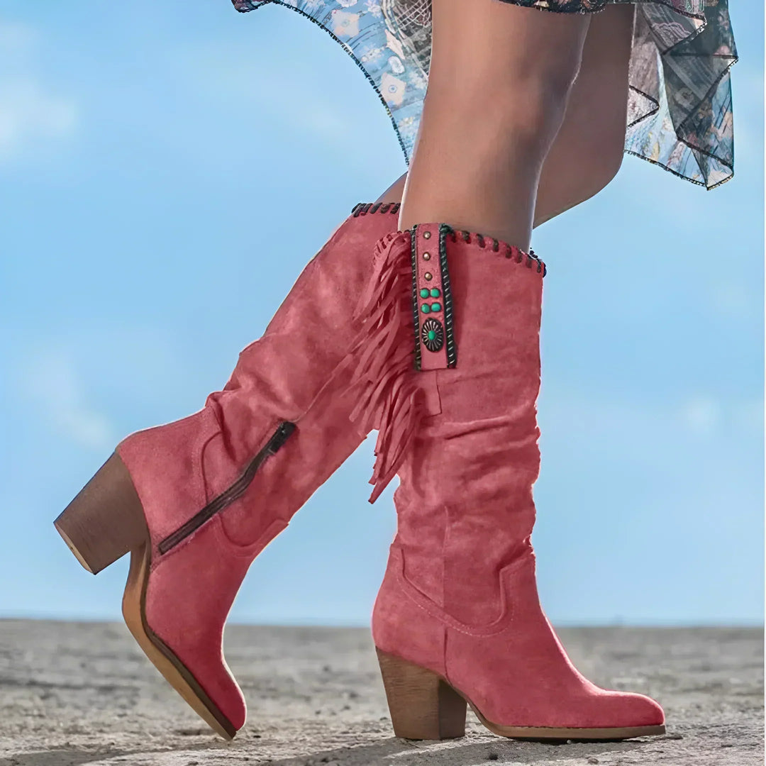 Detail shot of women's mid-calf cowgirl boots, showing fringe, block heel & turquoise accents.