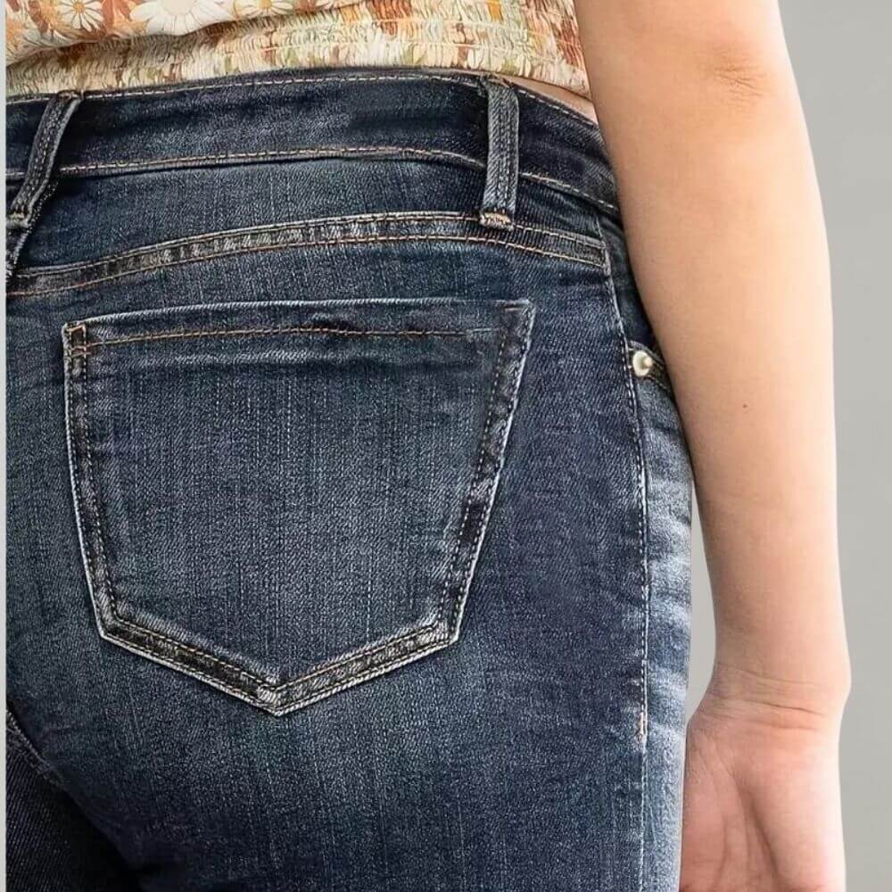 Stylish women's mid-rise stretch blue jeans, featuring a slim fit and fashionable flared leg.