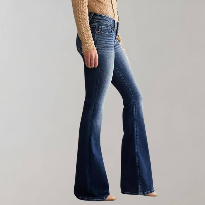 Comfortable mid-rise slim fit women's blue flared jeans, made from stretch denim for everyday wear.