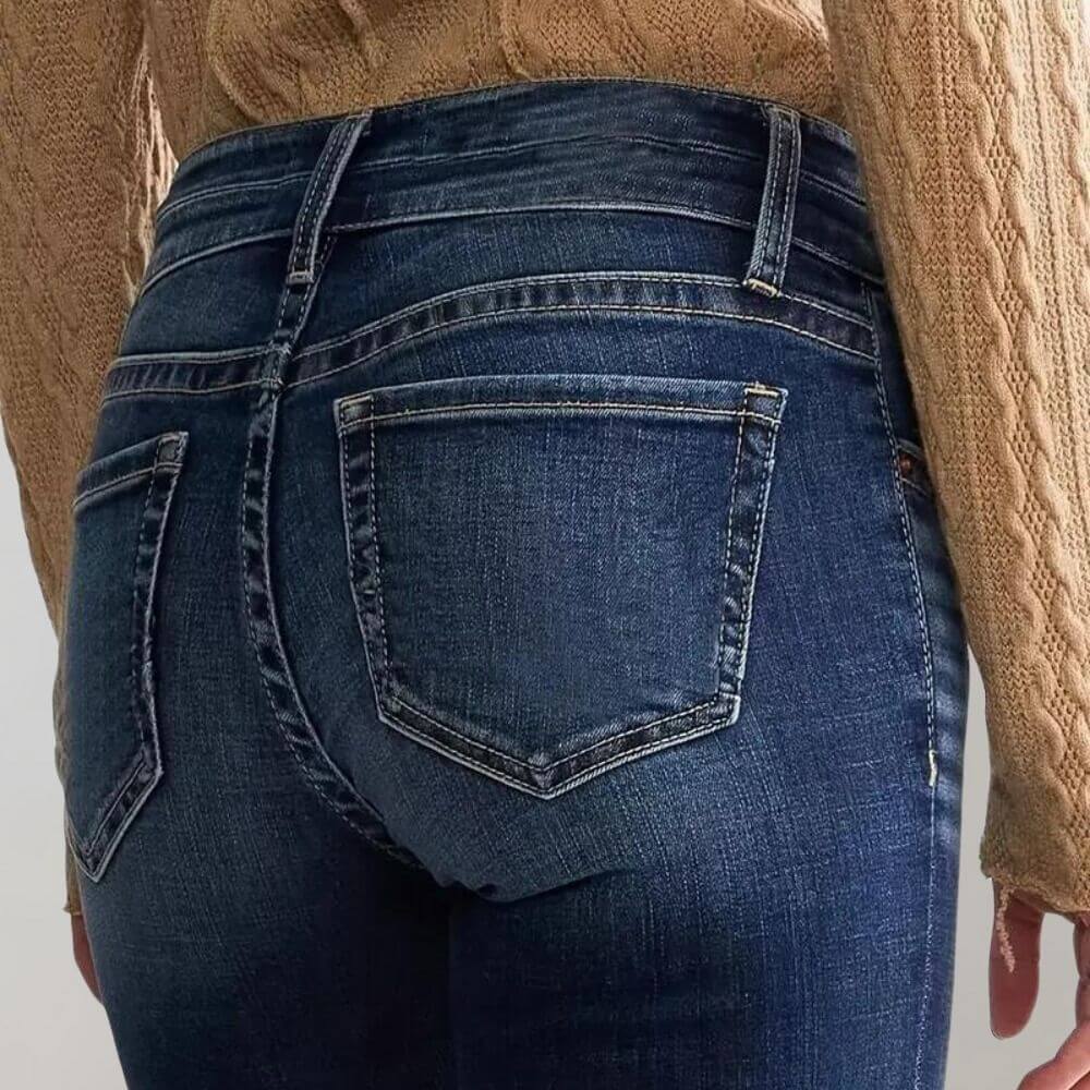 Fashionable women's retro blue flared jeans, featuring a mid-waist and flattering slim fit.