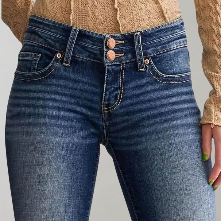 Classic blue stretch denim women's mid-waist jeans with a stylish slim fit and flared leg.
