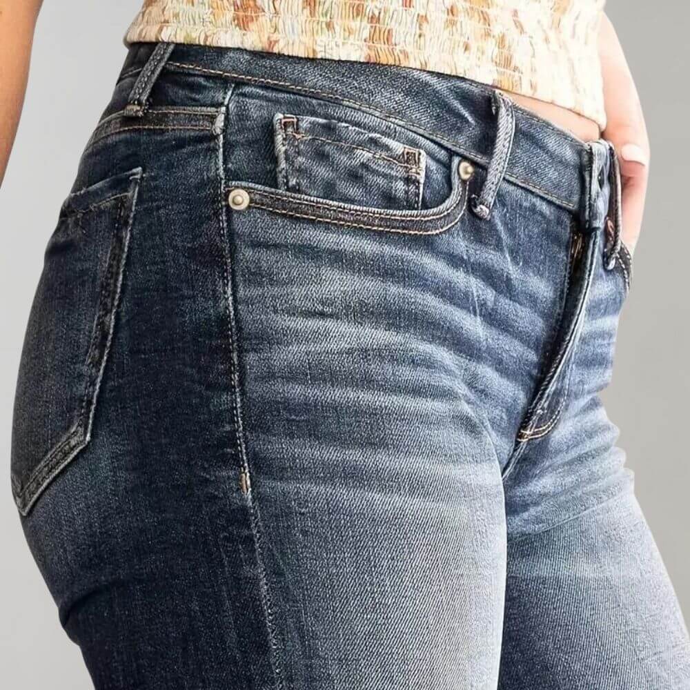 Blue stretch denim women's jeans with a flattering mid-waist, slim silhouette, and flared bottom.