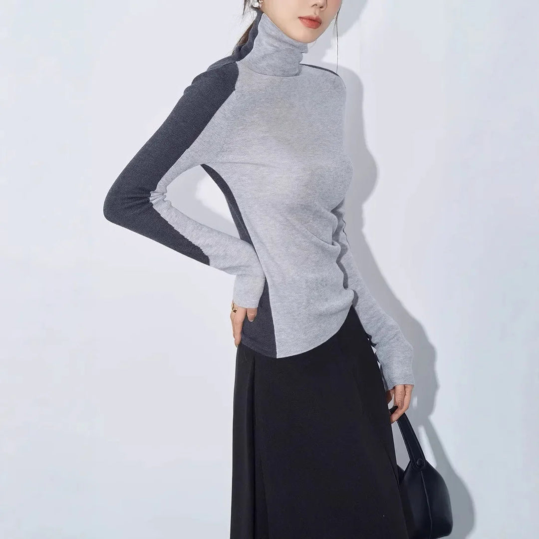 Women's fashion top: mock neck sweater with distinctive contrast sleeves. Modern, sophisticated, and comfortable.