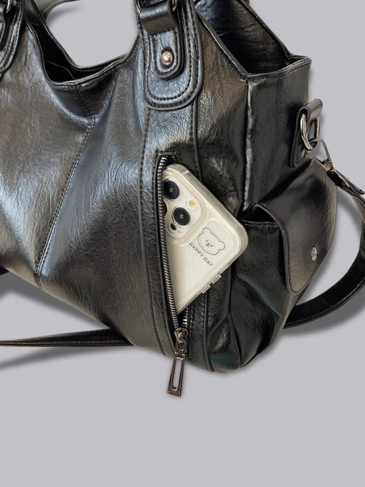Chic women's multi-pocket leather shoulder bag, versatile for work or casual outings.
