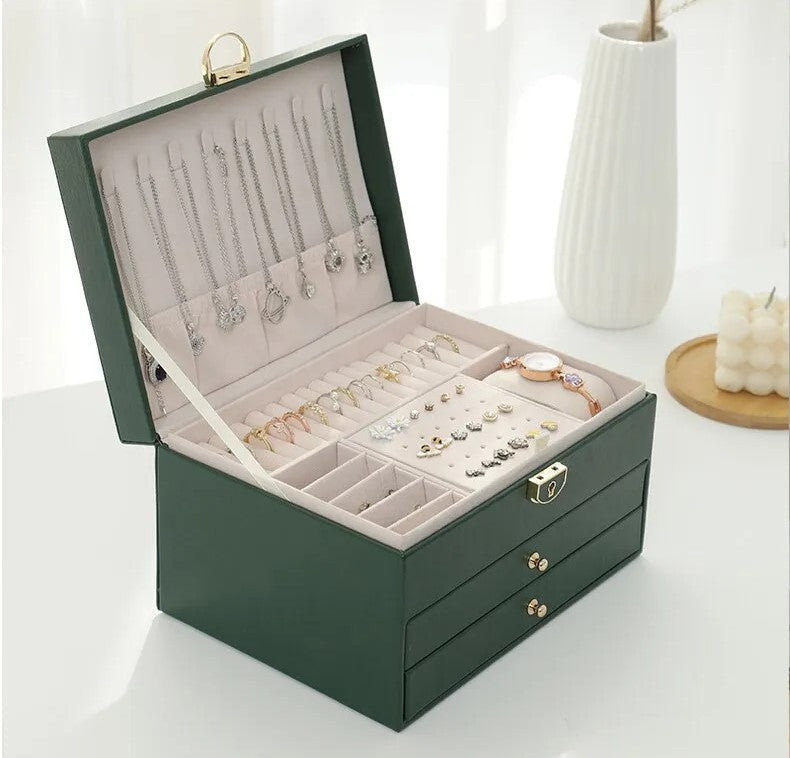 Multilayer leather jewelry box organizing women's accessories neatly on a dresser surface.