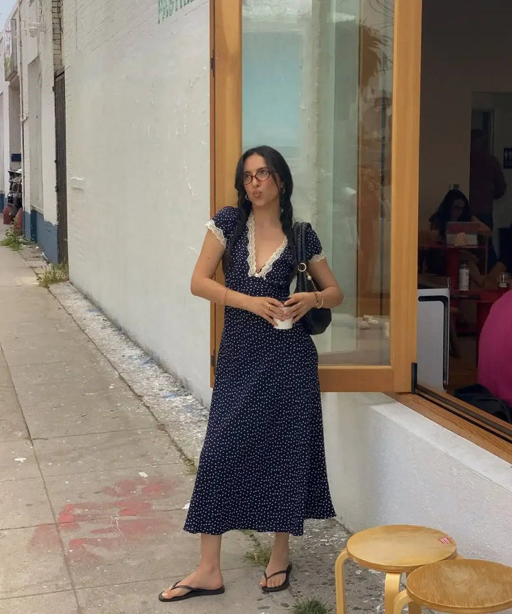 Elegant women's polka dot midi dress perfect for summer events. Features light fabric and flattering flutter sleeves.