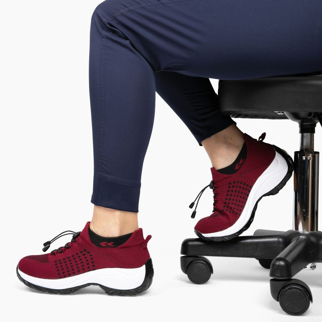 Black non-slip healthcare shoes for women, featuring a breathable stretch knit