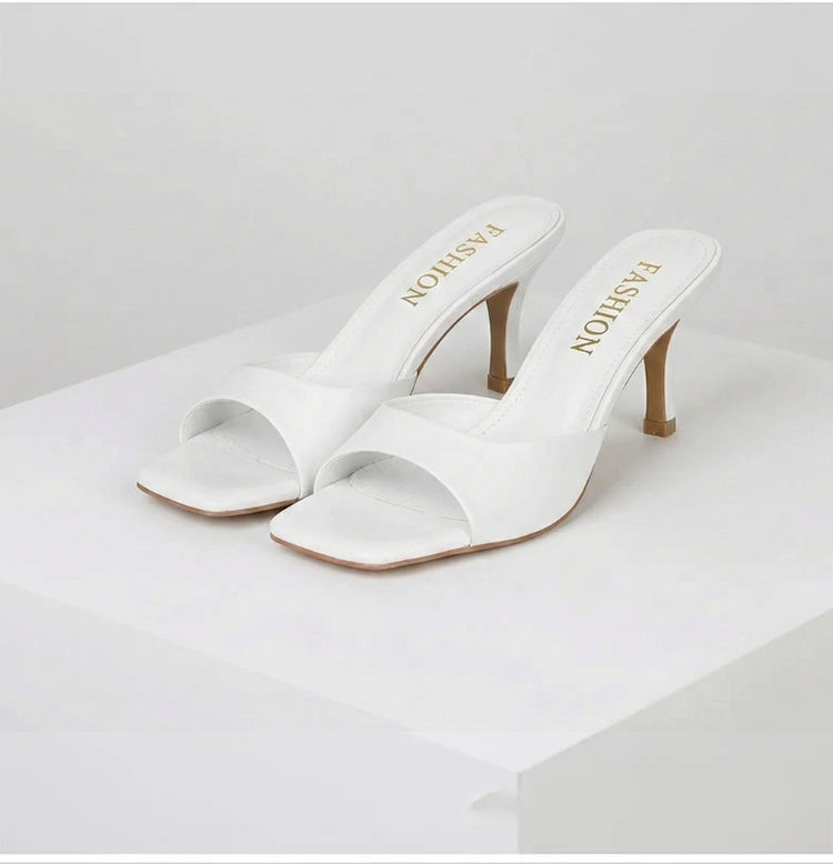 Fashion-forward open-toe mules for women, featuring a sophisticated square heel. Versatile summer shoes.