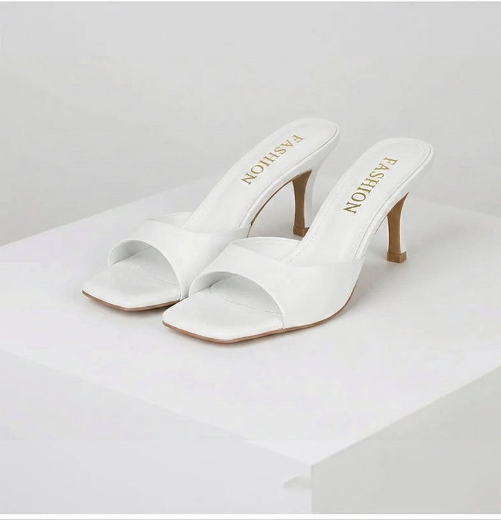 Fashion-forward open-toe mules for women, featuring a sophisticated square heel. Versatile summer shoes.