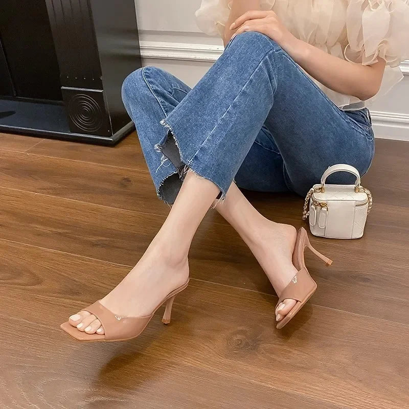 Fashionable women's open-toe mules with a stable square heel, ideal for sophisticated summer events.