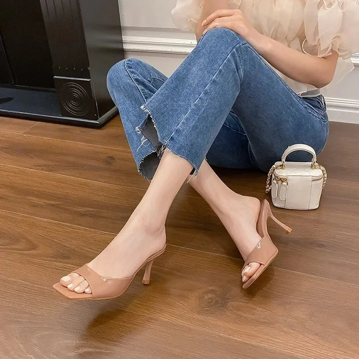 Fashionable women's open-toe mules with a stable square heel, ideal for sophisticated summer events.