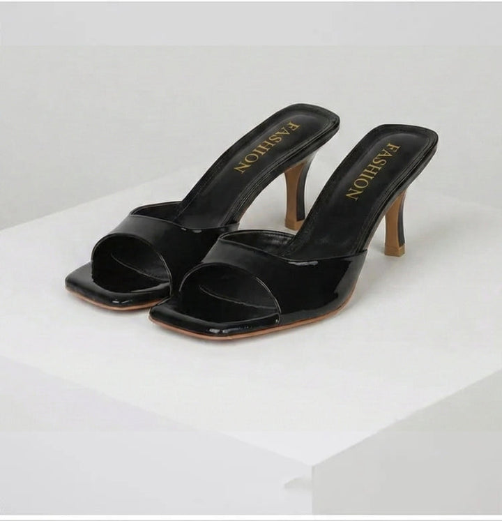 Modern women's open-toe mules with a unique square heel, offering elegant and chic summer footwear.