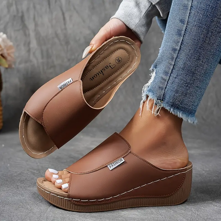 Comfortable women's slip-on wedge sandals with an open toe, perfect for summer outfits.