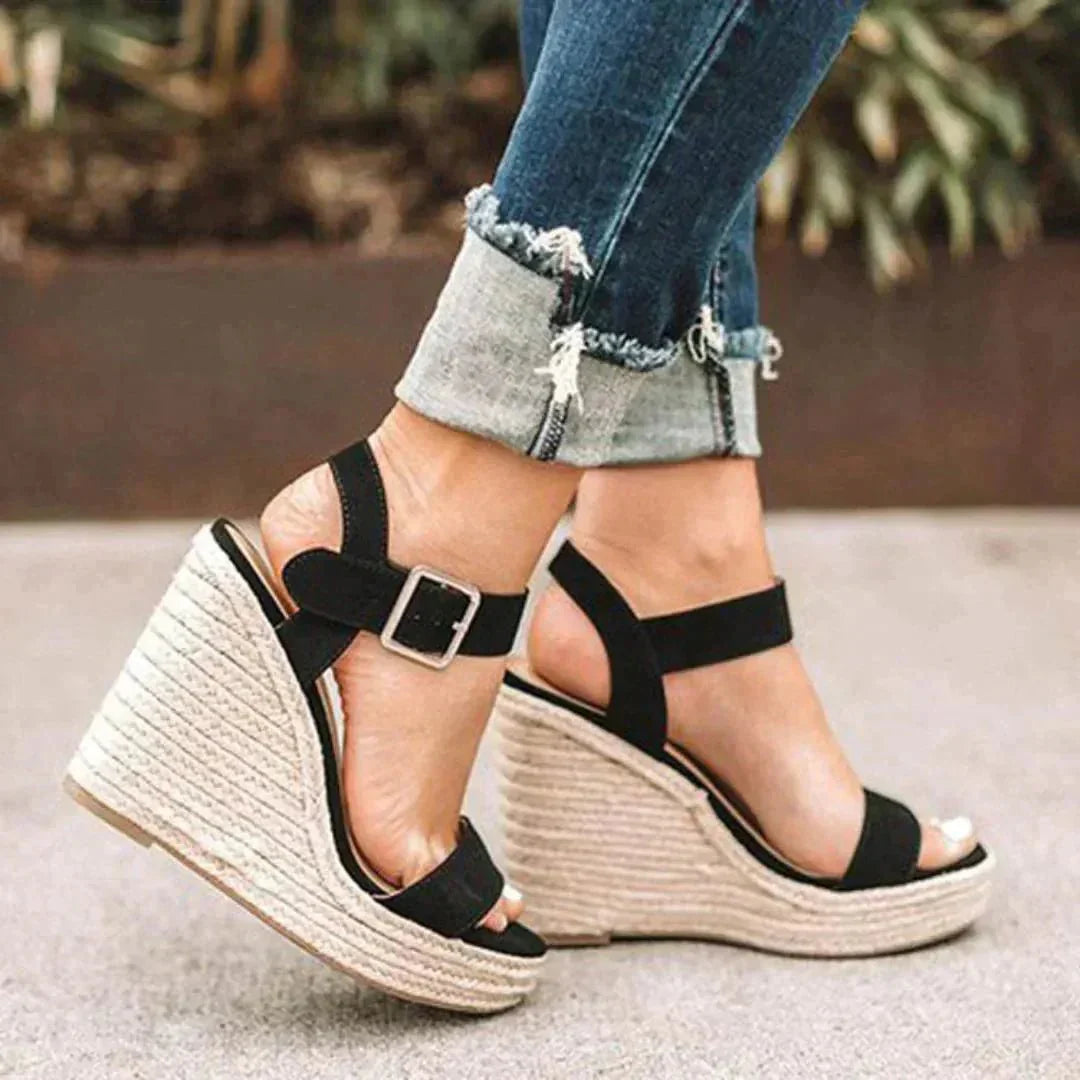 Stylish women's espadrille wedge sandals featuring an open toe and secure ankle strap, ideal for summer outfits.