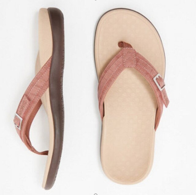 Closeup of women's flip flop with pronounced arch support for all-day comfort and posture correction.