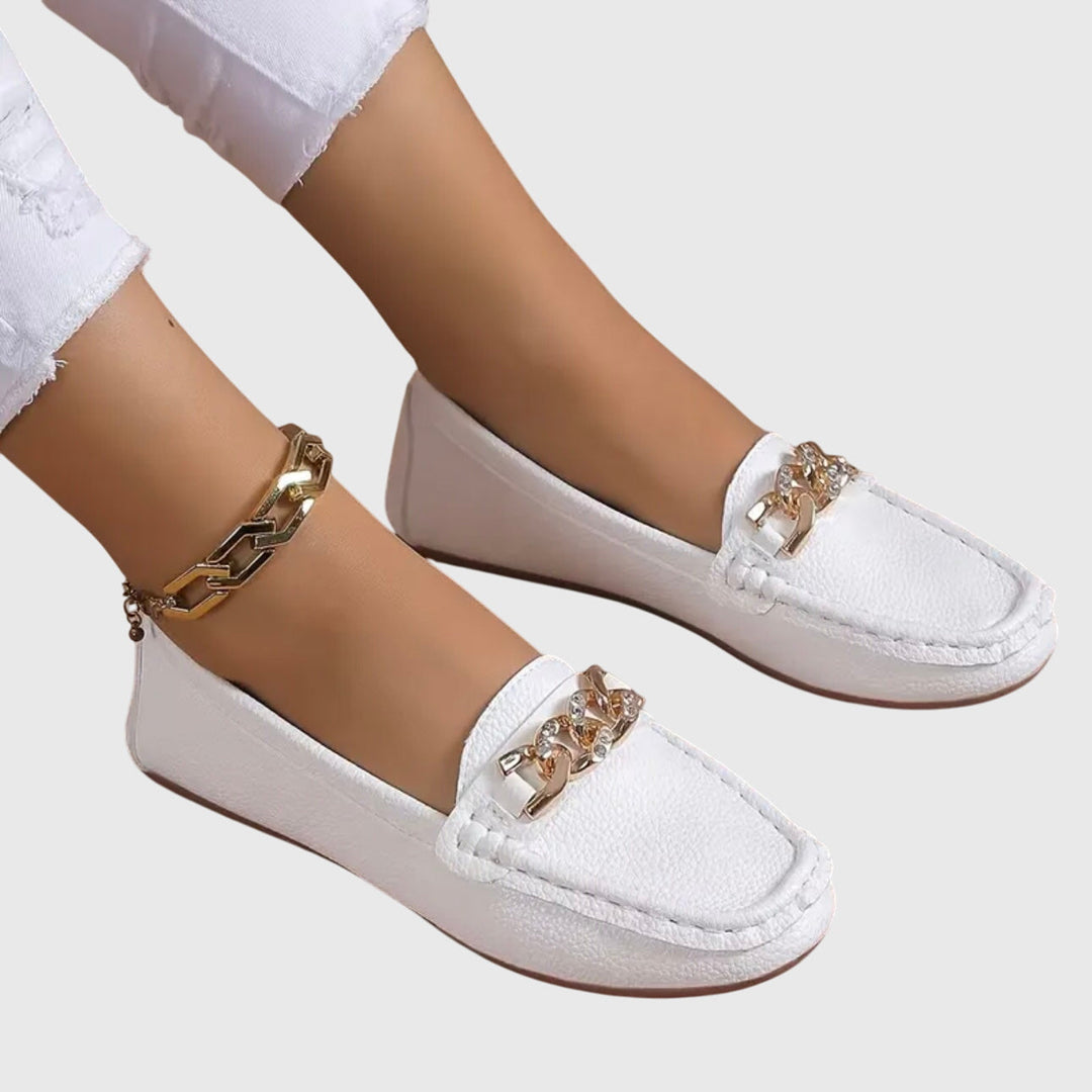 Neutral-colored women's loafers featuring orthopedic design for arch support, combining comfort & classic style.