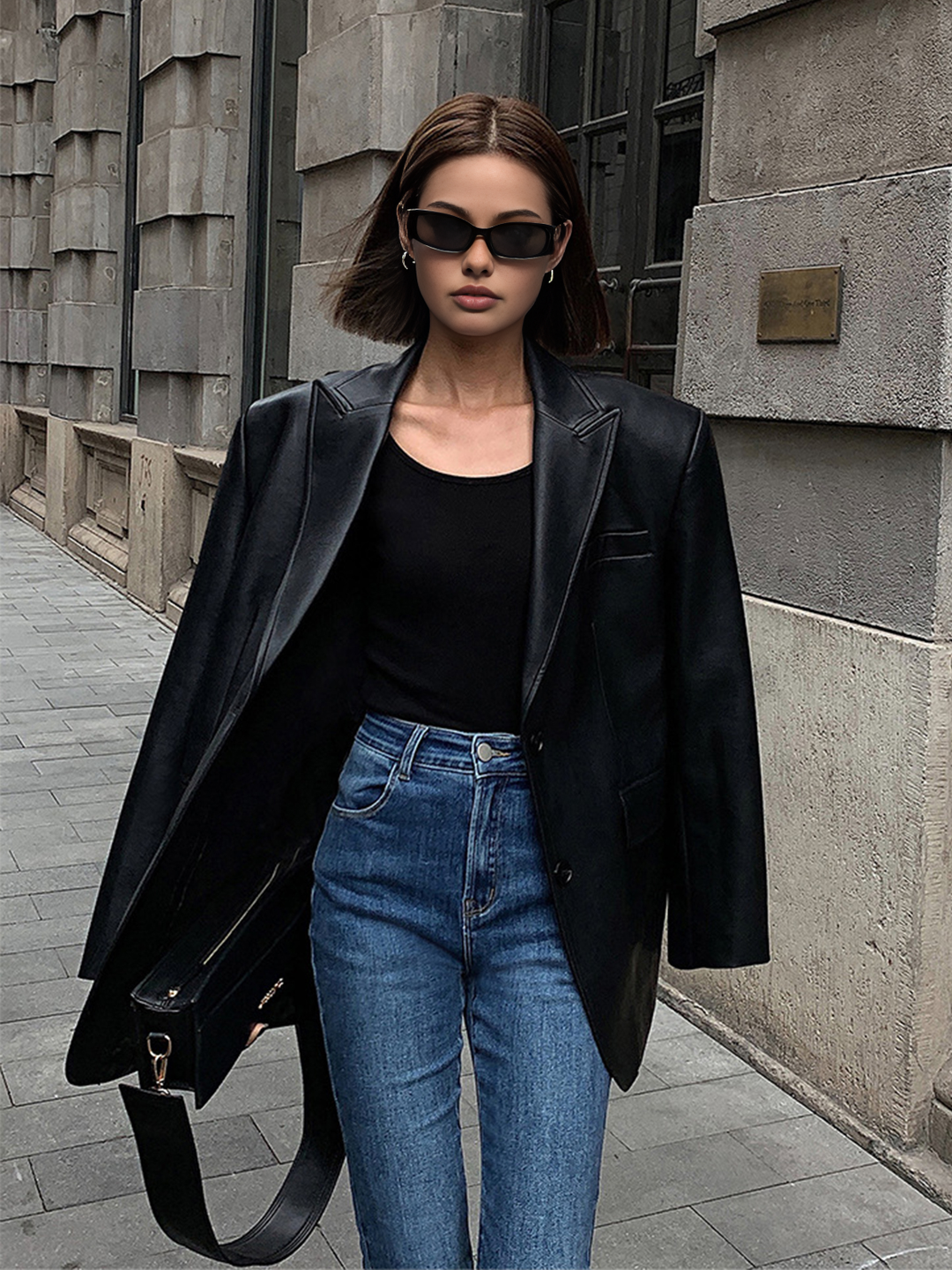 Modern women's oversized blazer in a black finish with a chic lapel, a stylish and versatile outerwear jacket.