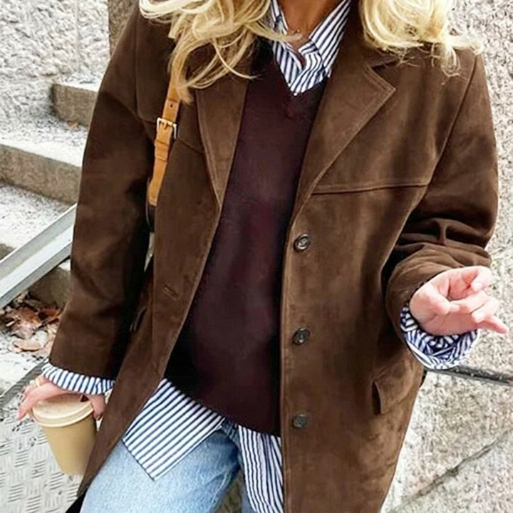 Chic women's brown oversized blazer with a classic notched lapel & front button closure. Great for versatile styling.