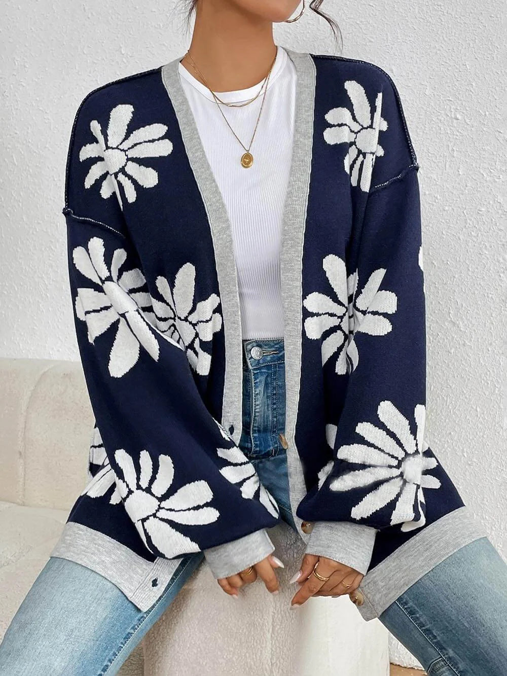 Fashionable women's oversized floral print cardigan. Cozy, casual layer ideal for autumn and spring styles.