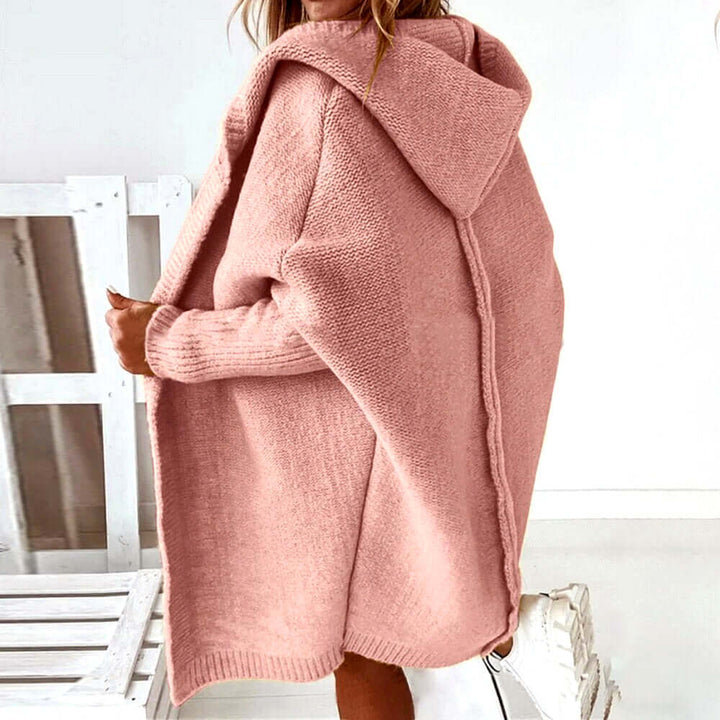 Cozy women's oversized hooded sweater with a soft knit texture. Ideal warm layering piece for casual chic style.