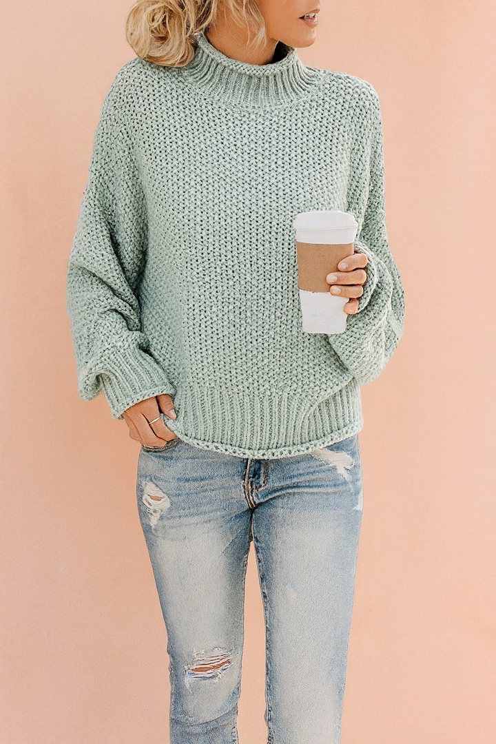 Women's oversized knit turtleneck sweater, cozy & warm chunky knit for winter comfort.