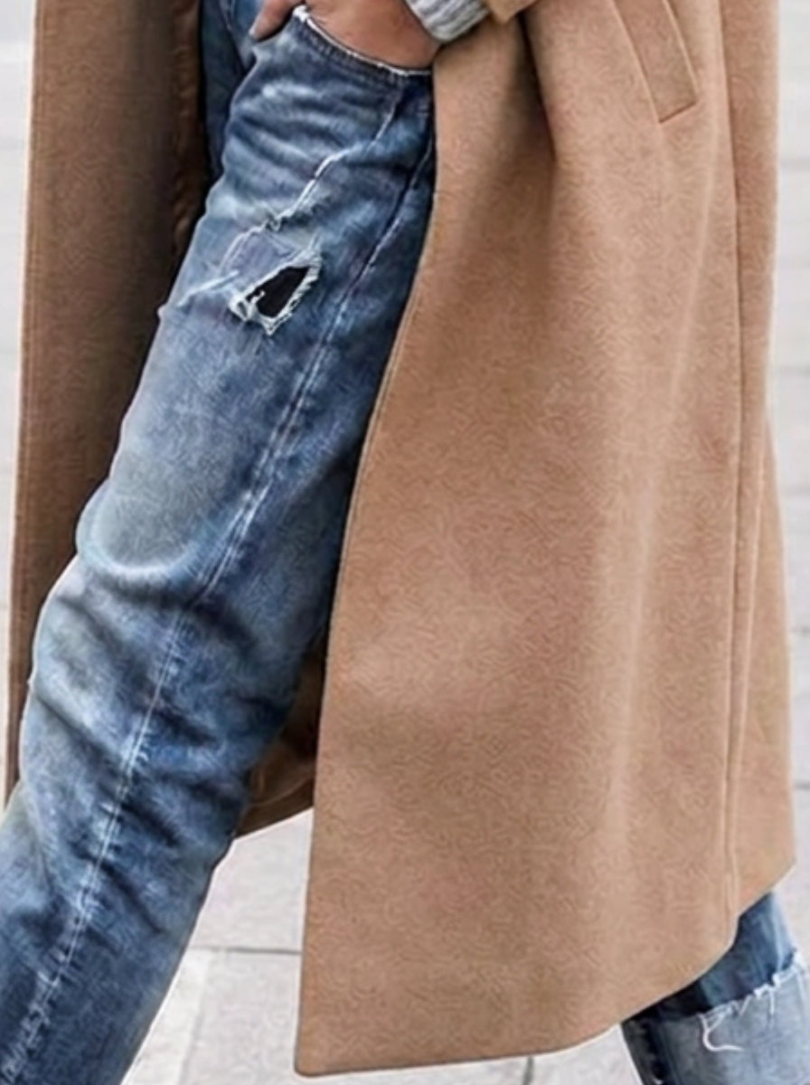 Stylish women's trench coat featuring oversized fit, long silhouette & classic lapel. Chic outerwear for any season.