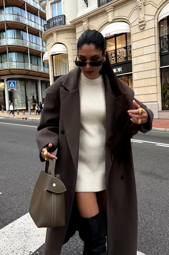 Elegant women's oversized longline coat. Double-breasted silhouette, a chic winter outerwear fashion staple.