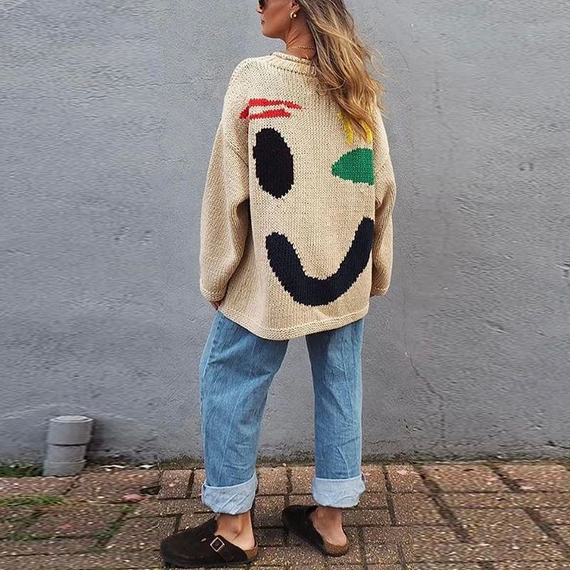 Trendy women's long sleeve oversized smiley face sweater, comfy knit for casual wear.