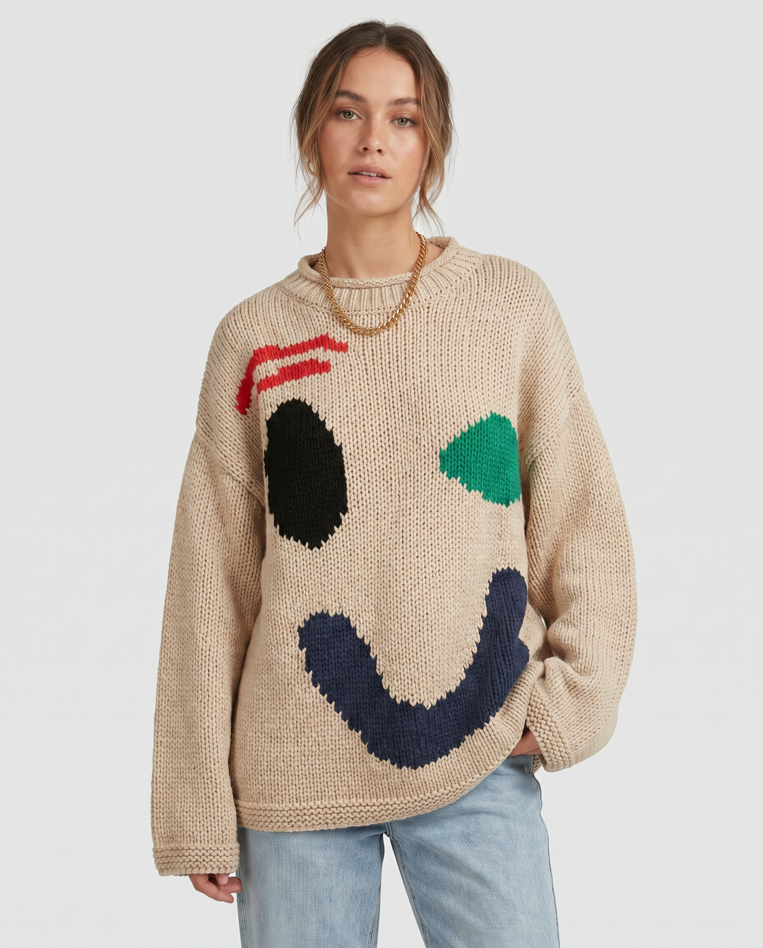Comfy women's oversized smiley face knit sweater, perfect for cozy layering and style.