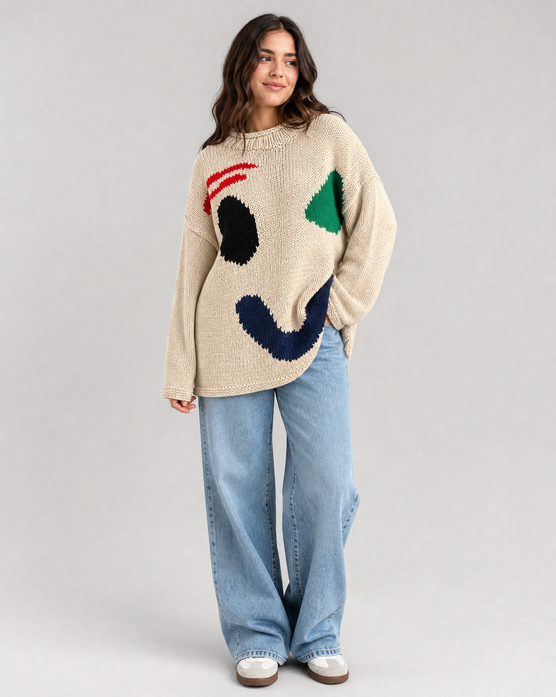 Cozy knit women's oversized smiley face sweater, long sleeve for stylish everyday wear.