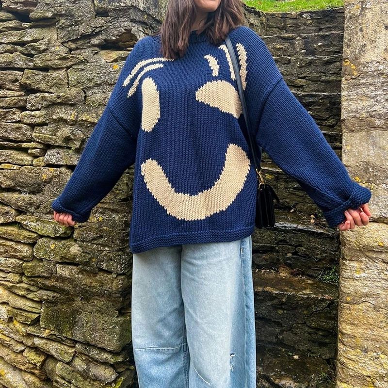 Soft women's oversized smiley face sweater, a relaxed fit knitwear for trendy fashion.