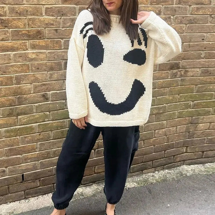 Trendy women's oversized smiley face knit sweater, cozy pullover for comfortable style.