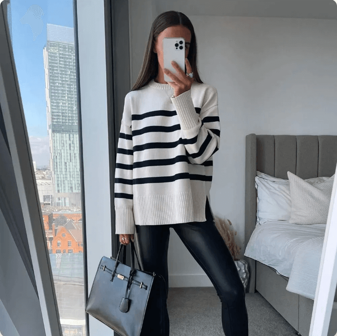 Women's oversized striped knitted jumper in a comfortable cotton blend, perfect for fall and winter cozy wear.