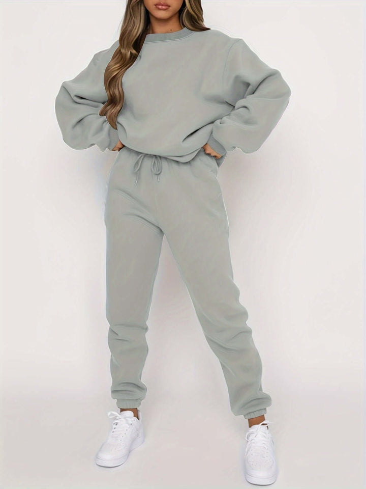 Cozy women's loungewear set featuring an oversized sweater and soft joggers, perfect for relaxed comfort at home.