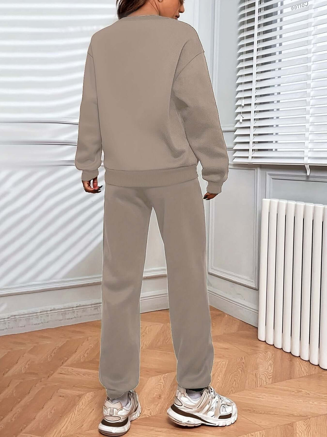 Complete women's oversized tracksuit set with a cozy long-sleeve sweater and comfortable joggers, a perfect duo.