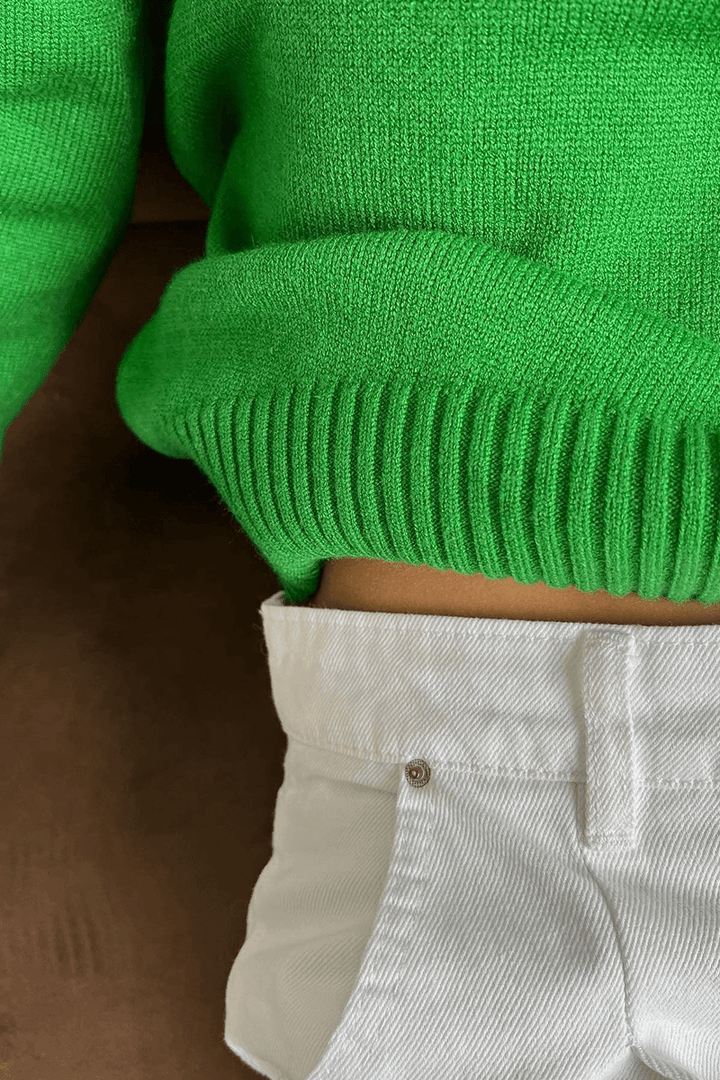 Warm women's oversized knitted turtleneck top, perfect for a cozy and stylish winter season outfit.