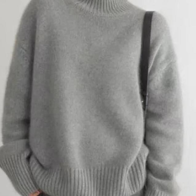 Cozy knit women's oversized turtleneck sweater, an elegant top for casual winter comfort.