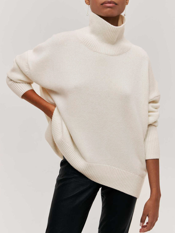 Close-up of cozy knit fabric on women's oversized turtleneck sweater, warm & comfortable winter wear.