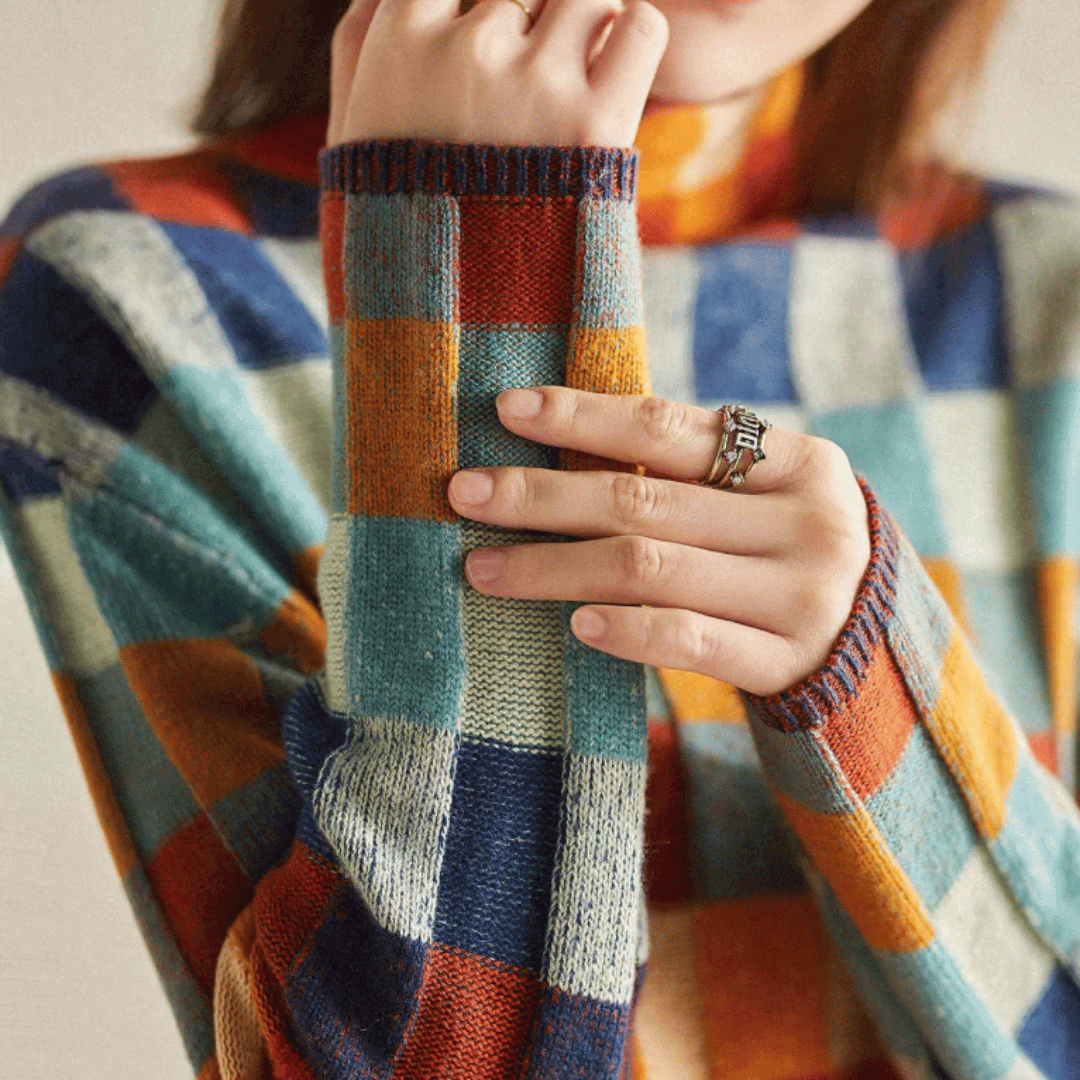 Warm orange patchwork cashmere turtleneck sweater for women, a cozy and stylish knitwear piece.