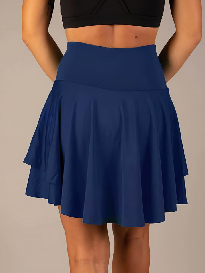 Athletic women's tennis skort for peak performance, featuring shorts and hidden pockets.