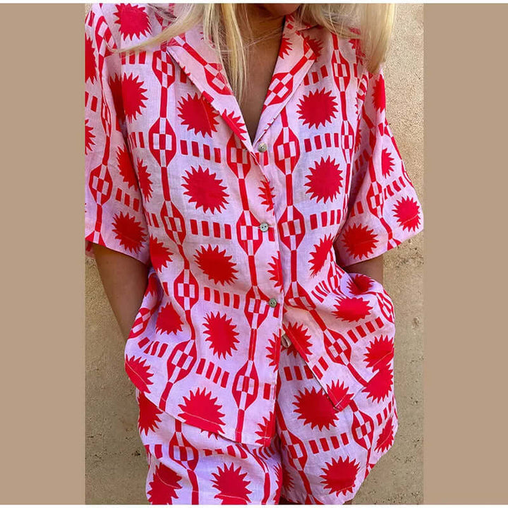 Stylish women's geometric print shorts set. Pink casual two-piece co-ord, perfect for a trendy summer outfit.