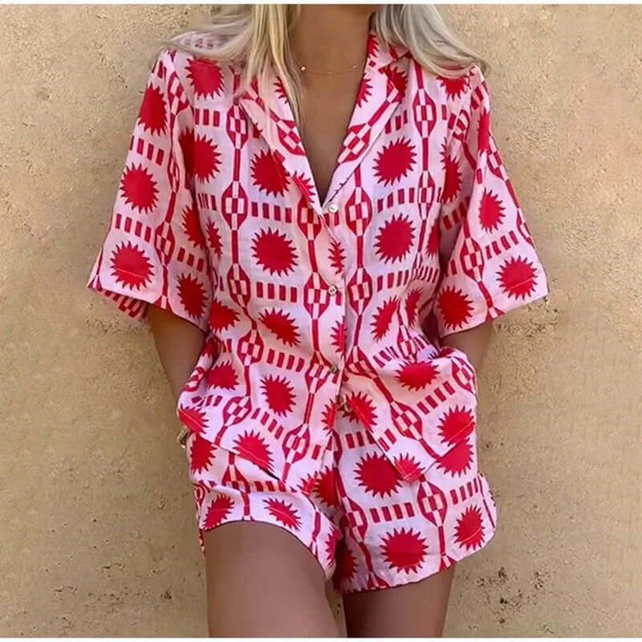 Vibrant pink geometric print women's co-ord set. Trendy two-piece shorts set, ideal for summer casual fashion.