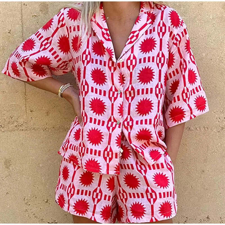 Fashionable women's geometric print matching set. Pink two-piece co-ord with shorts for summer casual style.